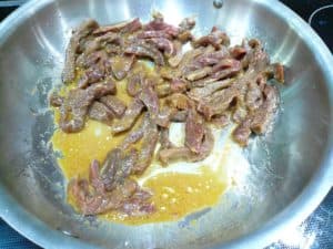 Add the beef strips to the hot pan